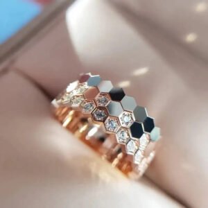 Three honeycomb stacking rings with sparkling stones worn as a full stack on one finger