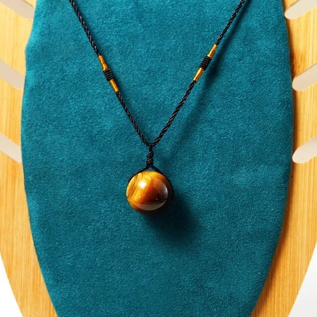 Tiger eye necklace in a gold-tone oval frame styled with an autumn outfit
