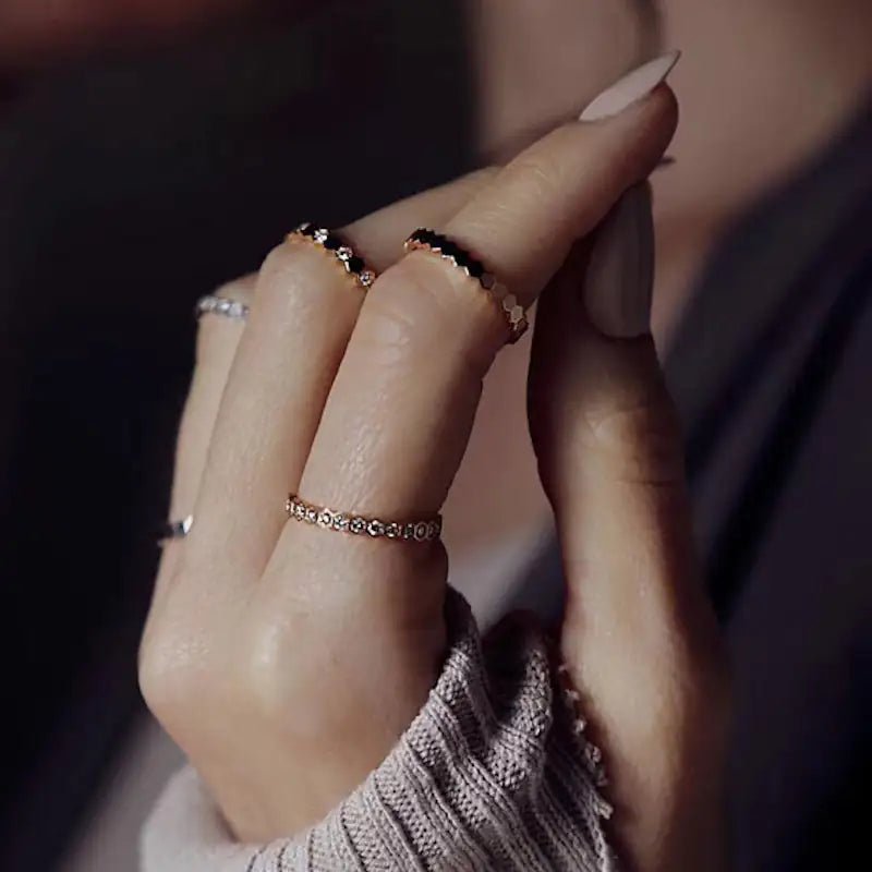 Honeycomb stacking rings in rose gold worn spread across several fingers